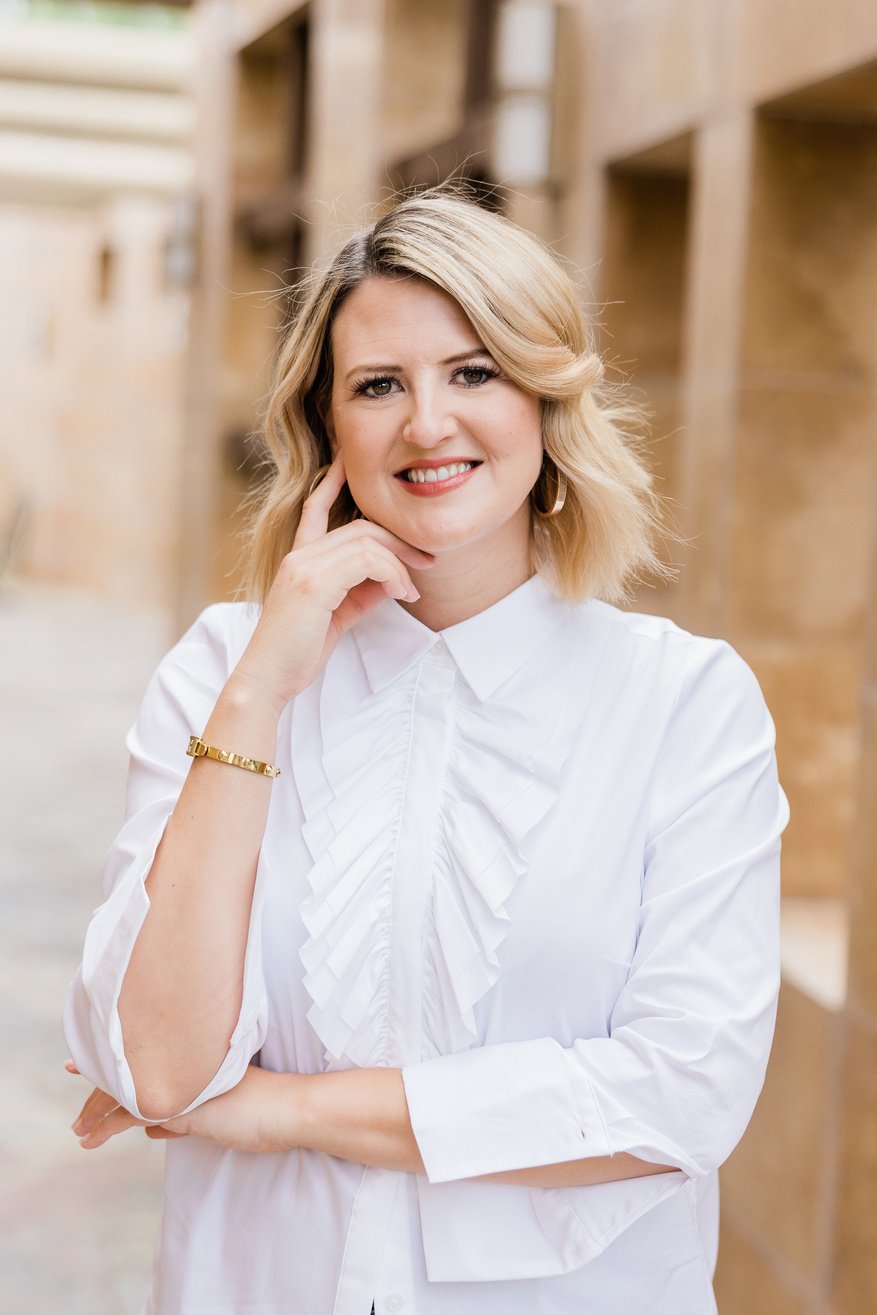 a person in a white shirt posing for the camera