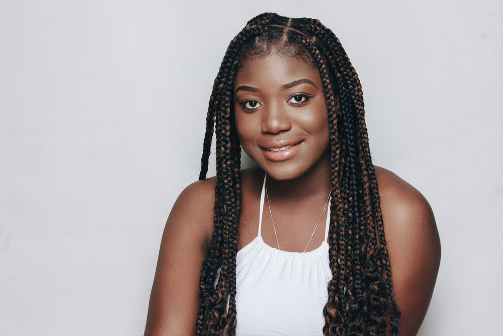 Portrait of a Smiling Woman with Black Hair in Dreadlocks